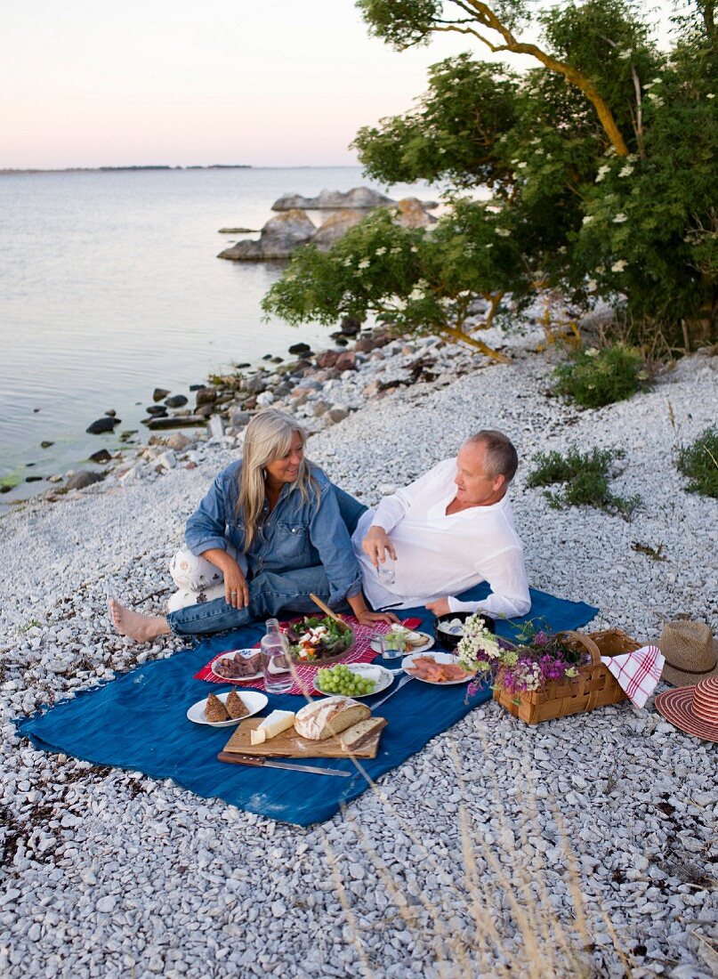 A couple having a picnic on a beach