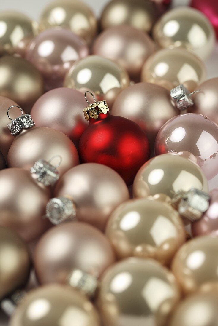 Pink Christmas baubles and one red one