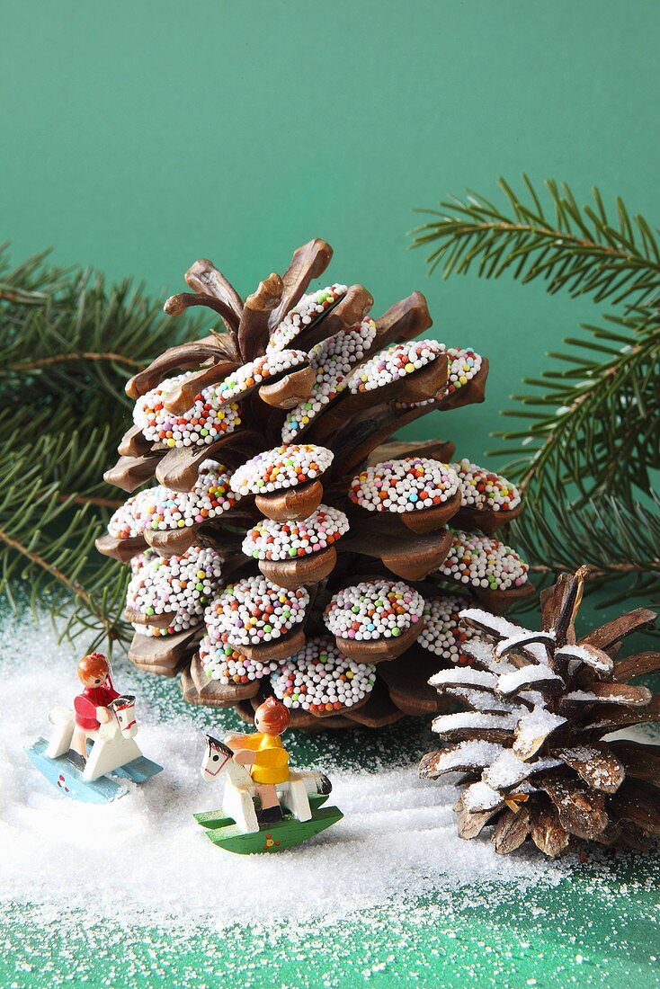 Jazzies on pine cones and small toy figures on rocking horses