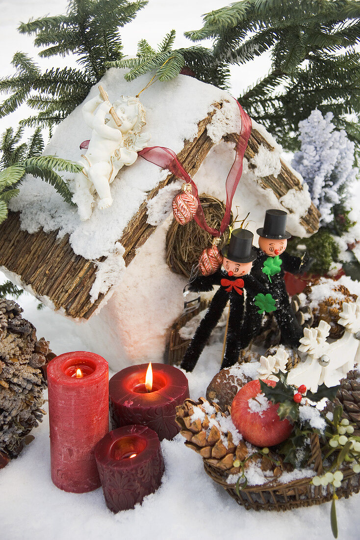 Christmas decorations and two chimney sweeps in snow