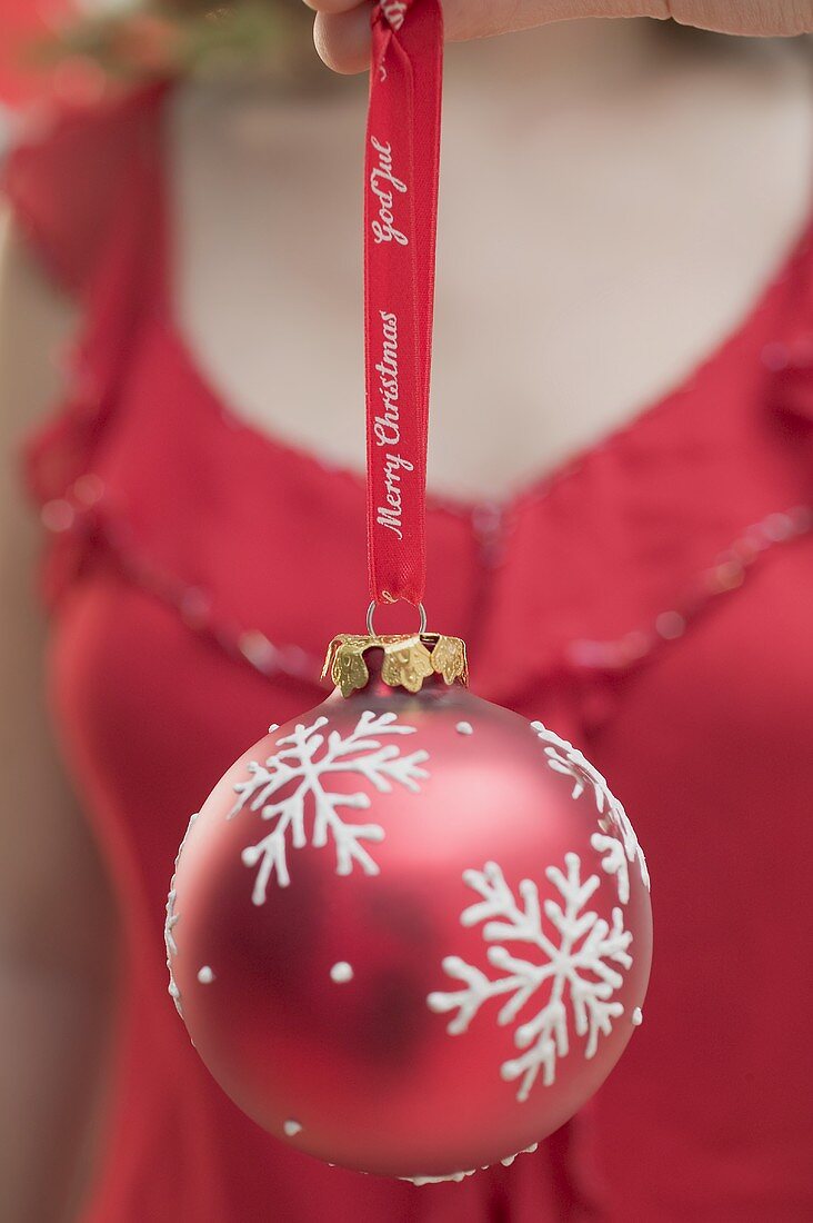 Woman holding red Christmas bauble