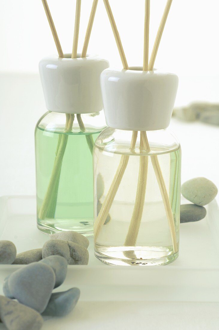 Two bottles of fragrance with aroma sticks