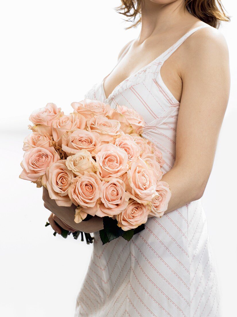 Woman with bouquet of pink roses