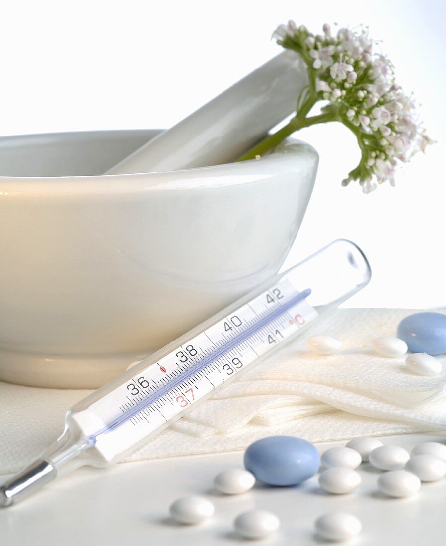 Tablets, clinical thermometer and valerian