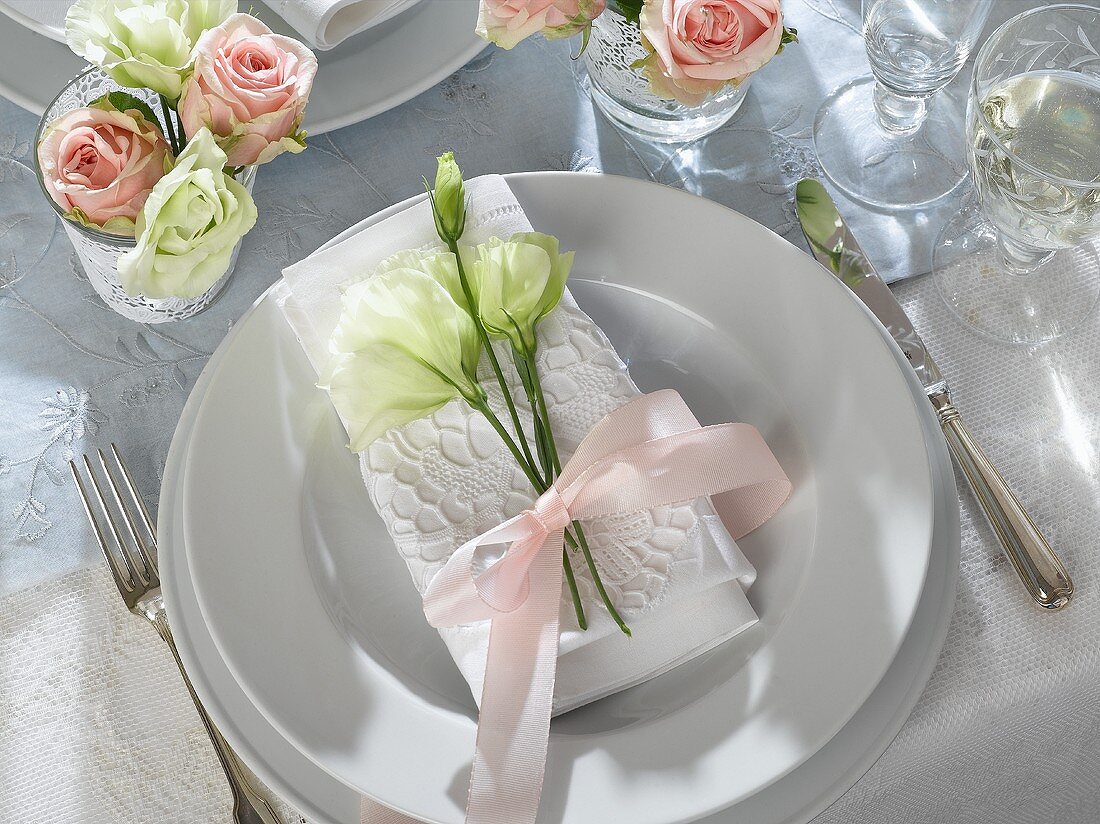 Place-setting for special occasion with napkin & lisianthus
