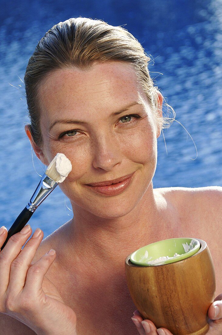 Woman with face mask and brush