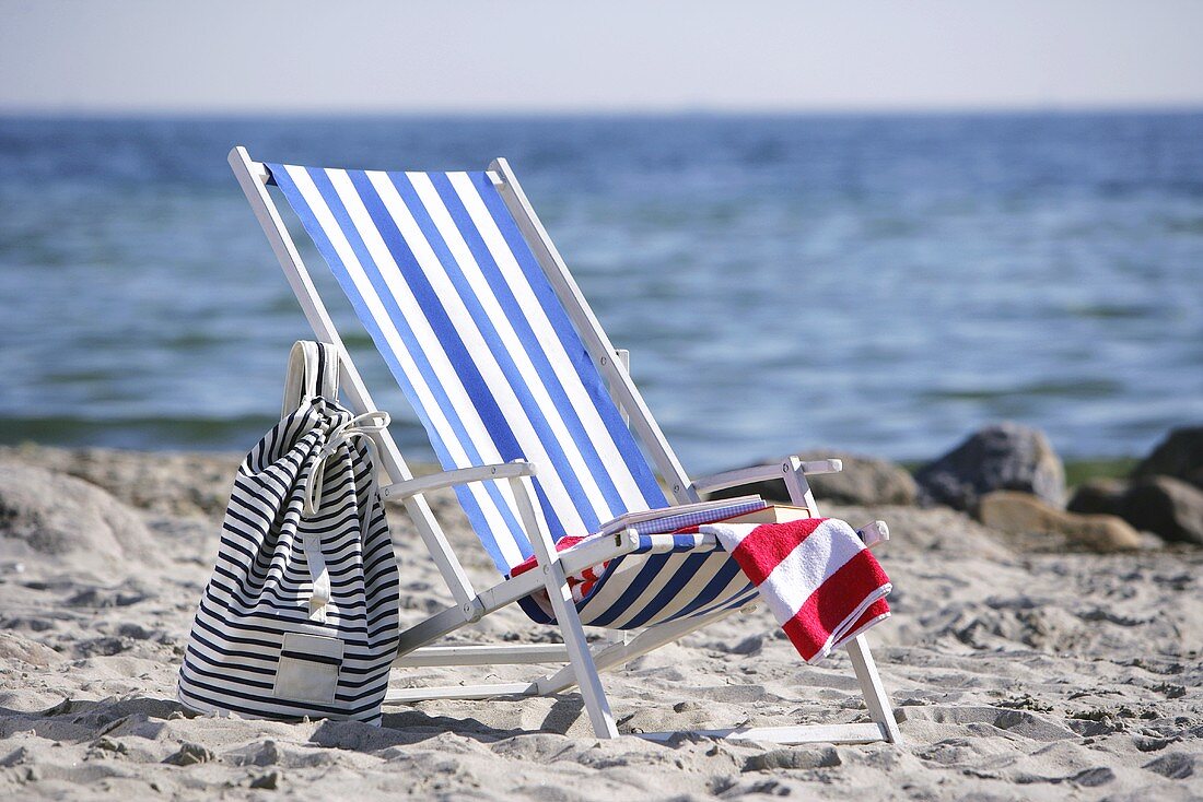 Blue and white striped deckchair by the sea
