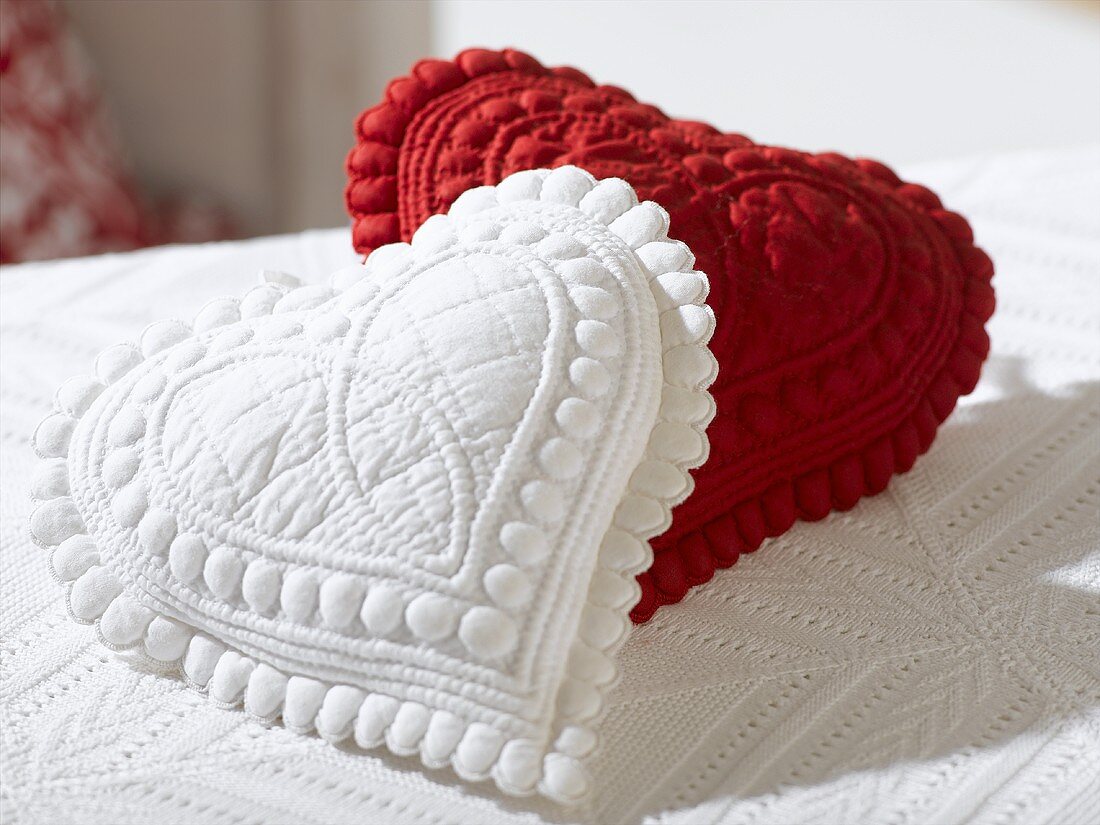 Two small heart-shaped cushions (red and white)