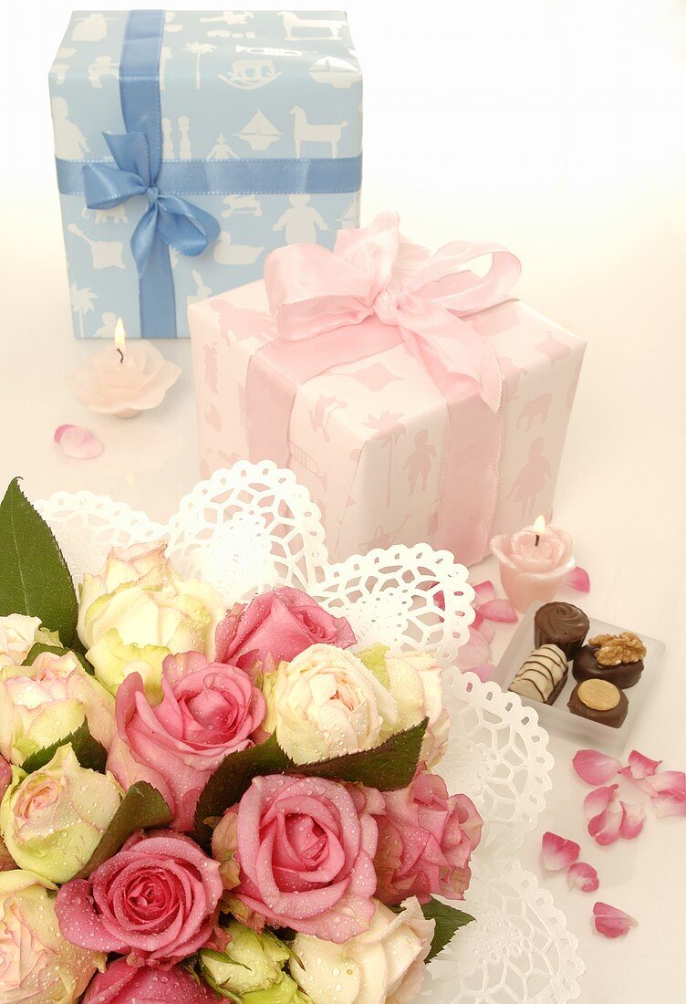 Two gifts, bouquet of flowers and chocolates