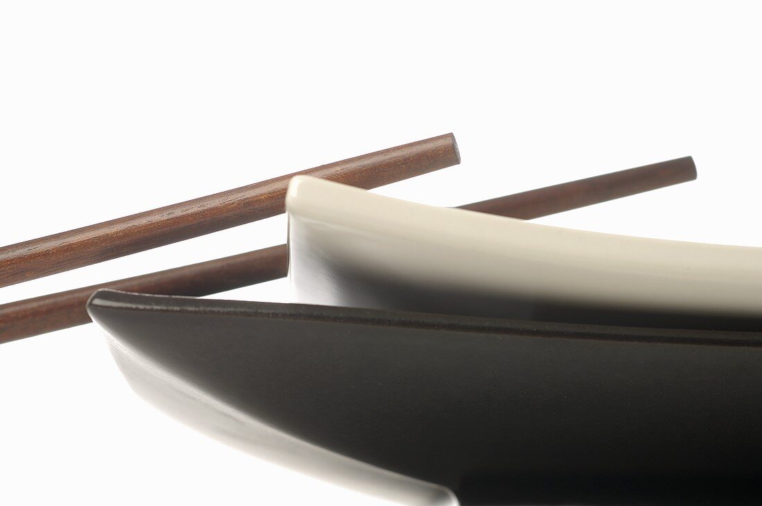 Chopsticks, a black and a white plate