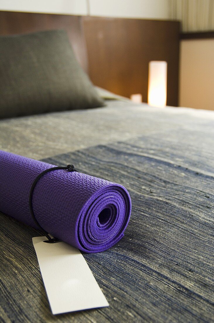 Yoga mat on a bed