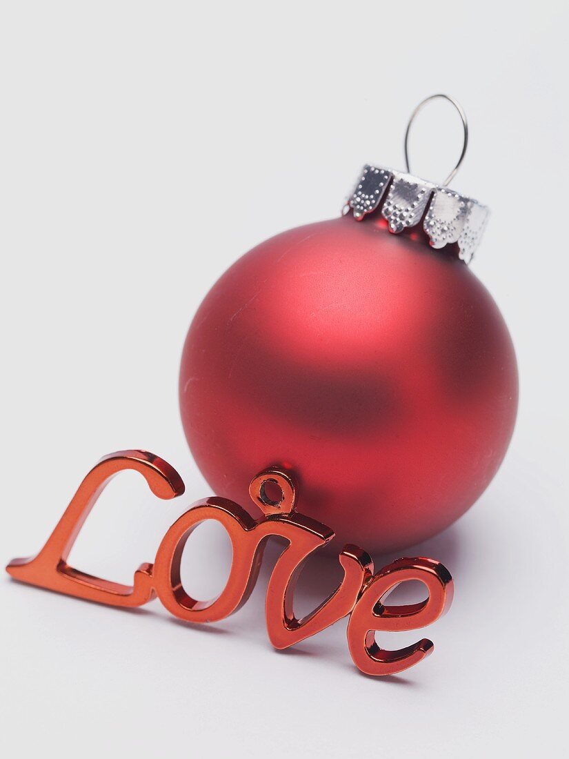 Red Christmas bauble and the word Love