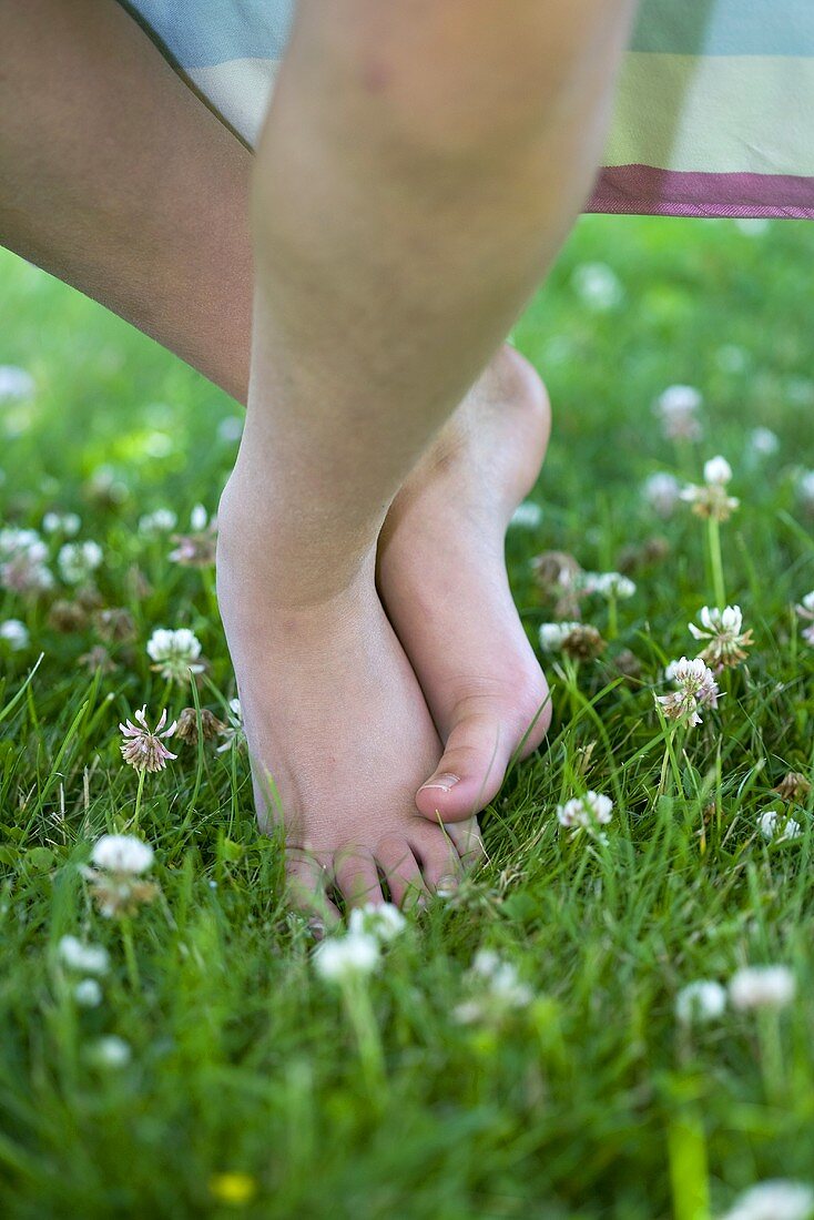 Feet on grass with white clover