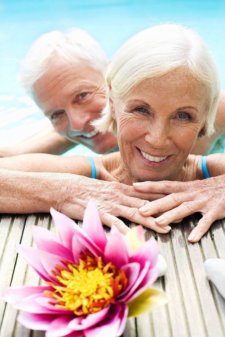 Germany, Senior couple in pool, close-up