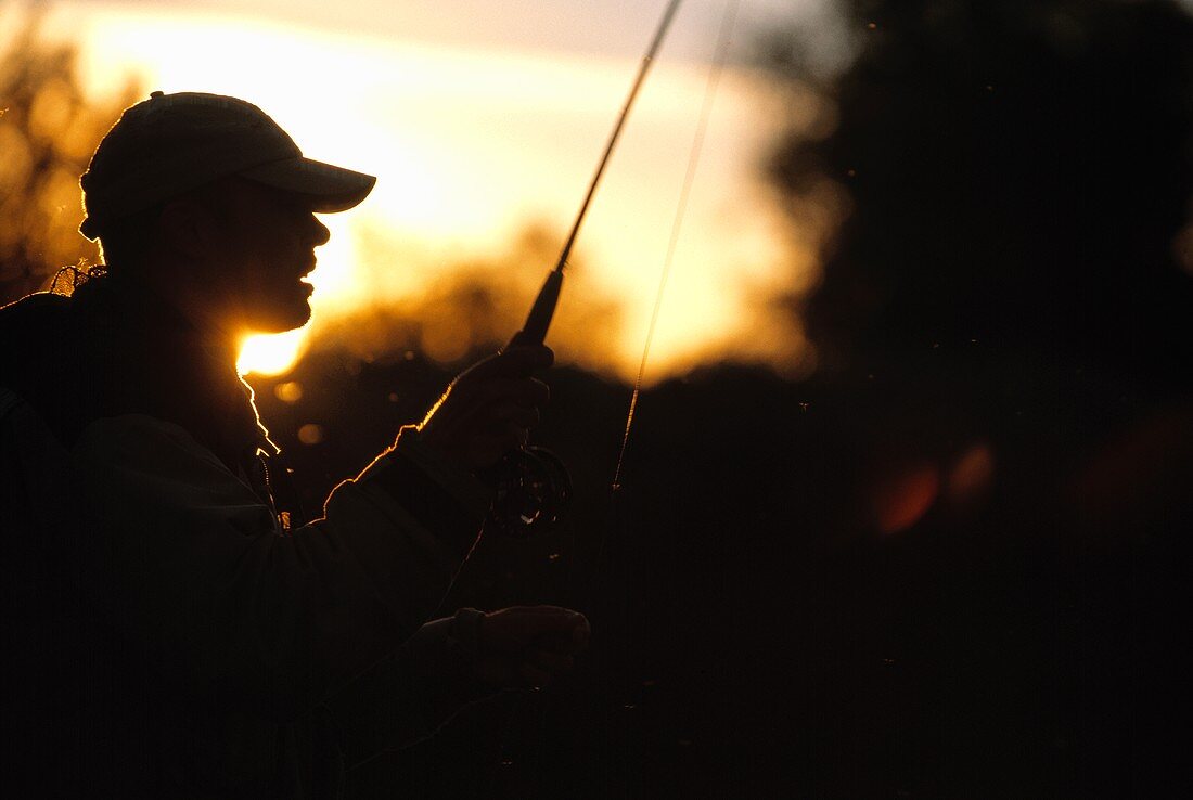 Fly fisherman at dusk