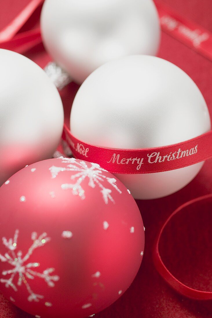 Red and white Christmas baubles with red ribbon