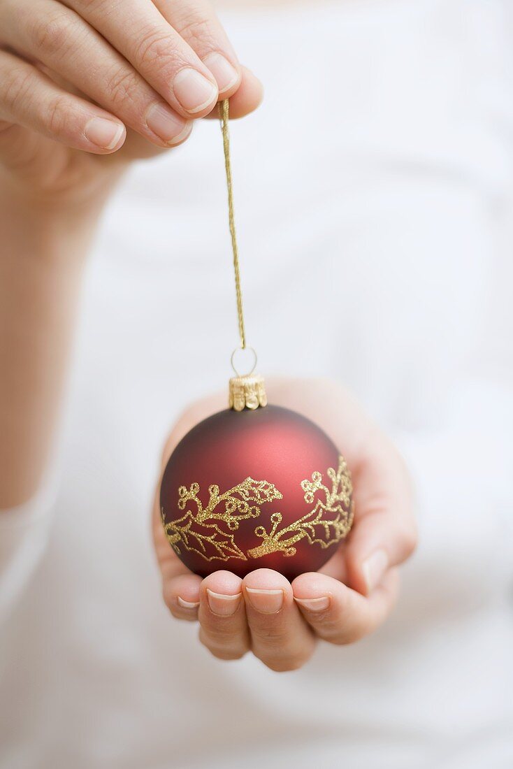 Hands holding Christmas bauble