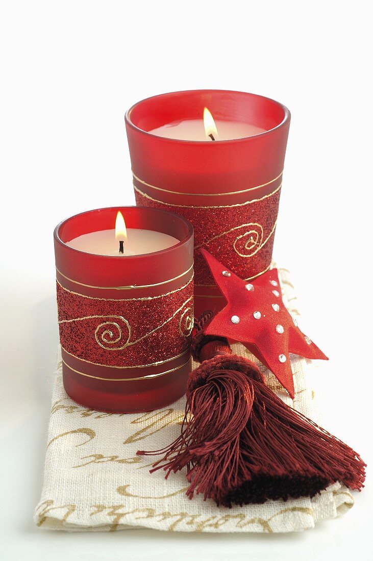 Candles in red glasses (Christmas decoration)
