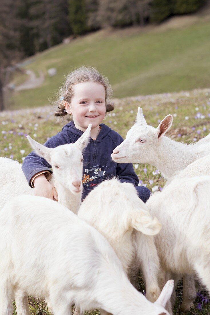 Little girl with kids in an Alpine pasture