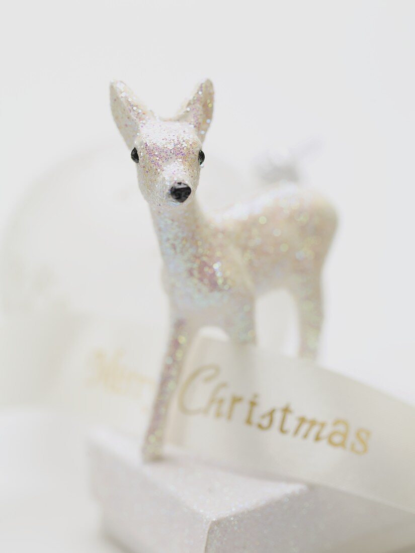 Christmas decoration (deer) on box with ribbon