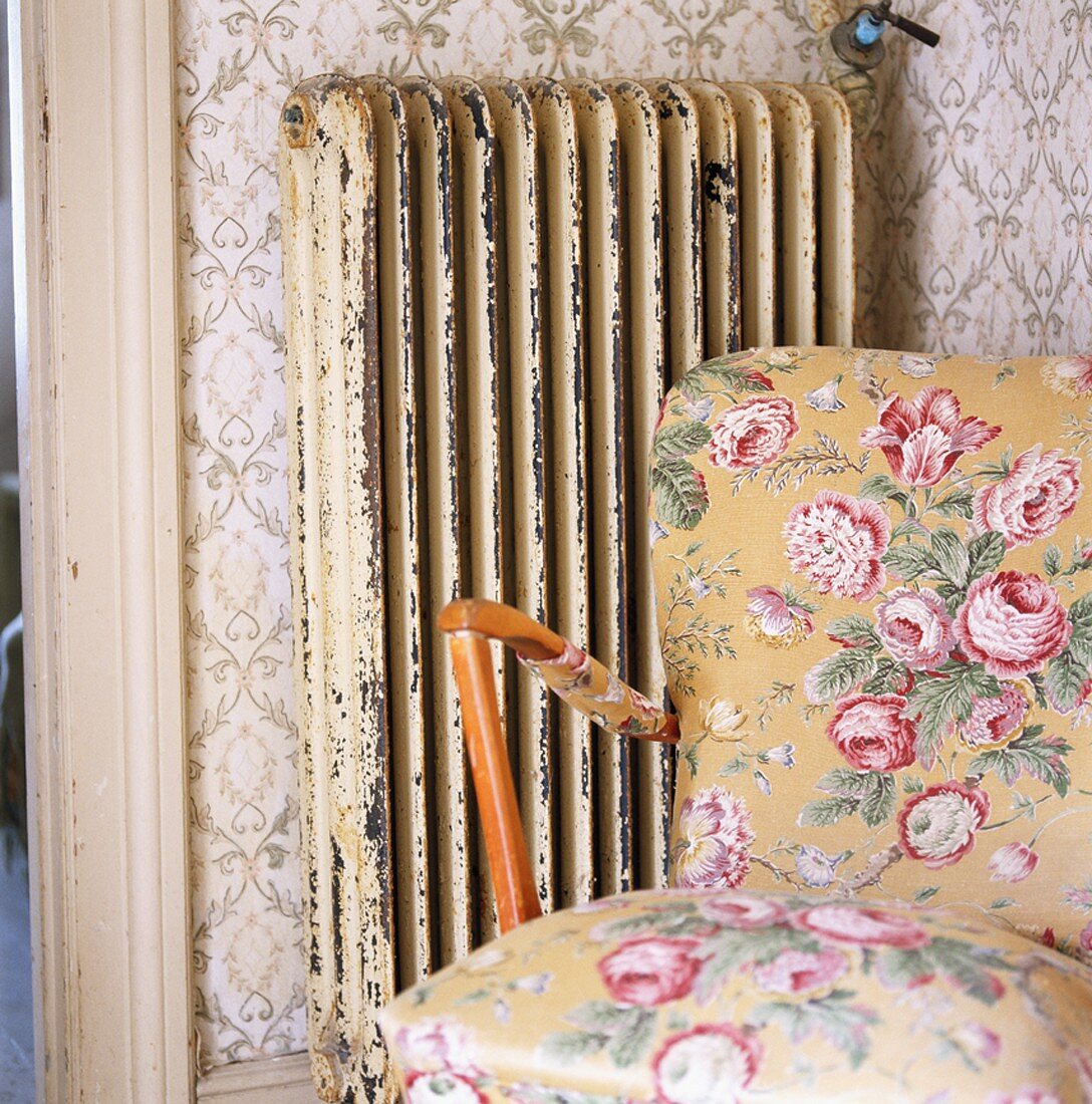 Flower-patterned armchair beside a radiator