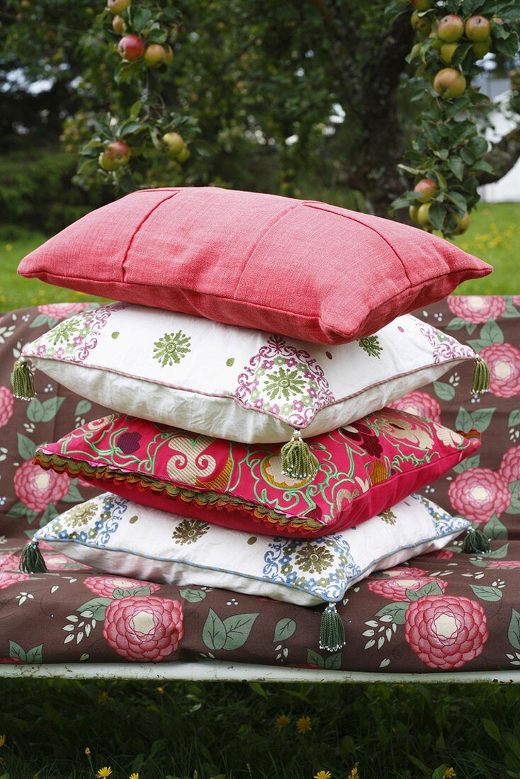 Colourful cushions on a garden bench