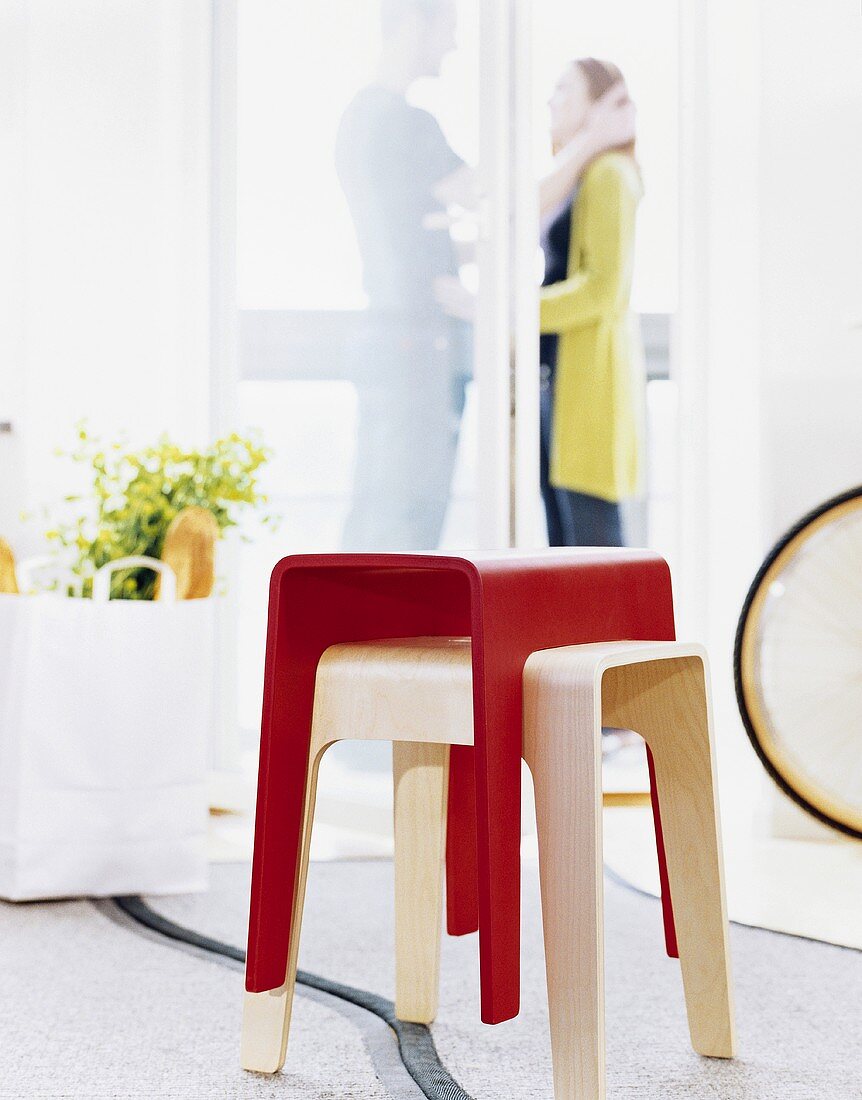 Two stools, man and woman in background