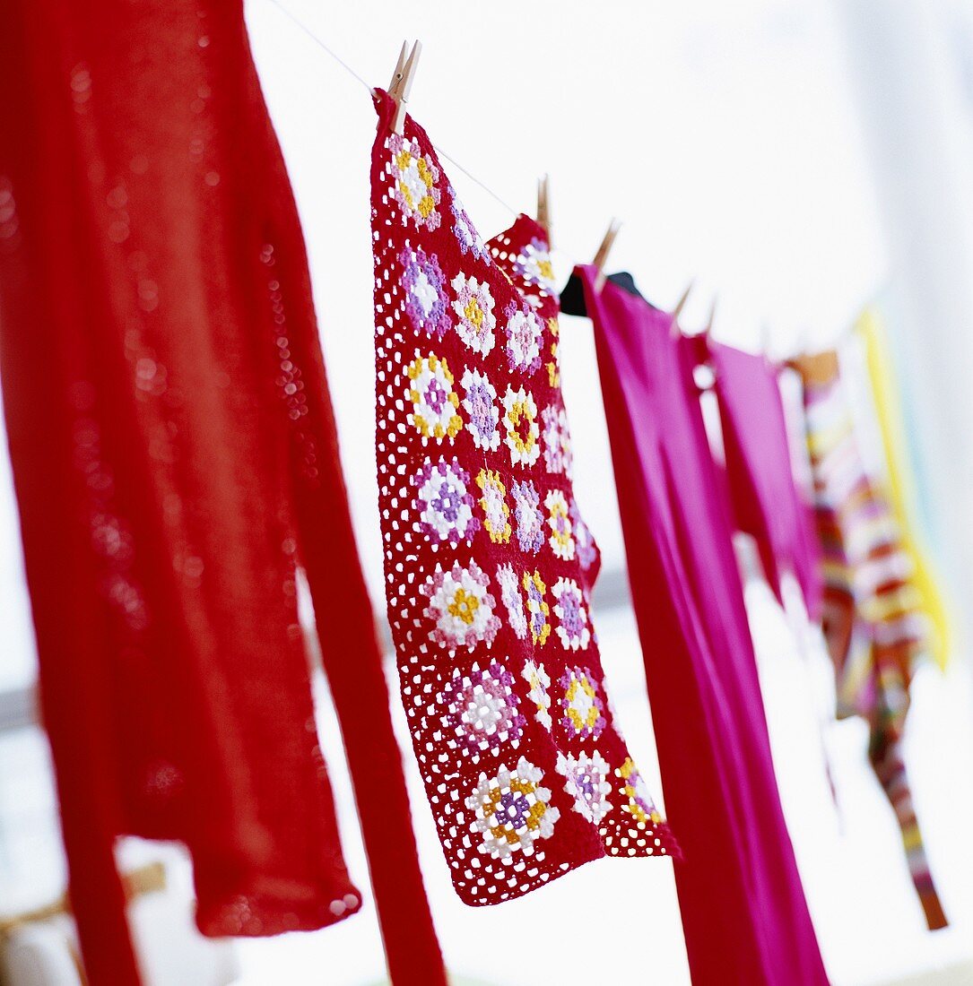 Colourful clothing and towels hanging on a washing line