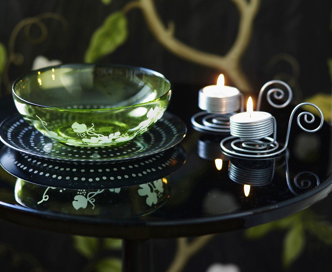 Glass bowl and tealights on side table
