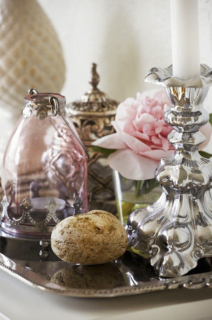 Silver candlestick, peony and carafe on tray