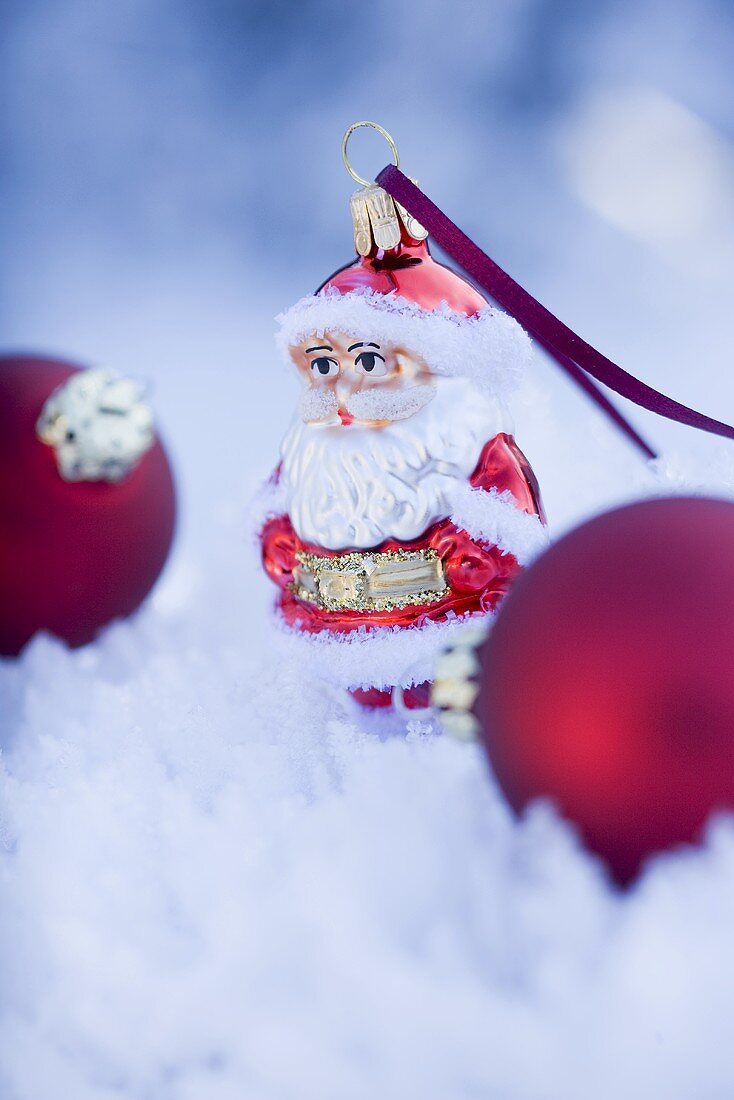 Father Christmas and Christmas baubles in snow