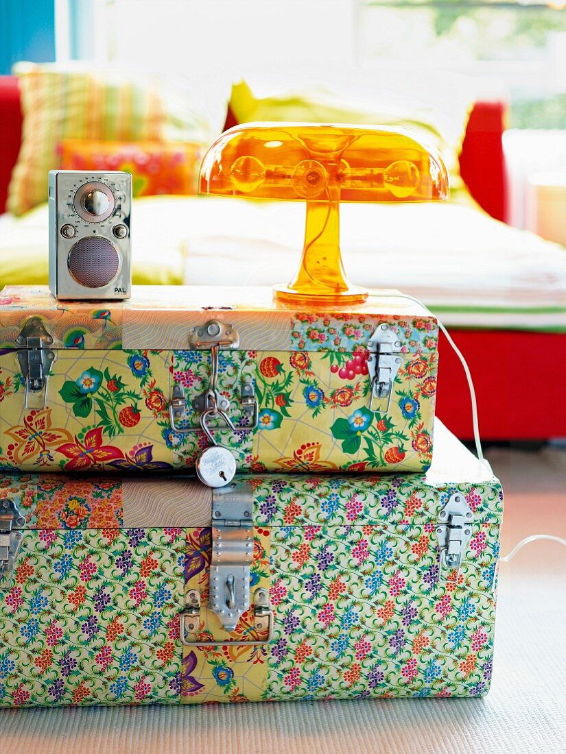 A stack of brightly patterned cases as a bedside table