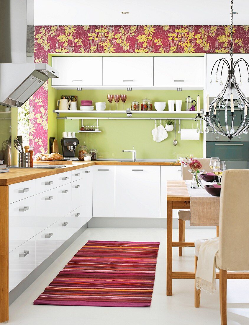 White kitchen-dining room with green and purple accents