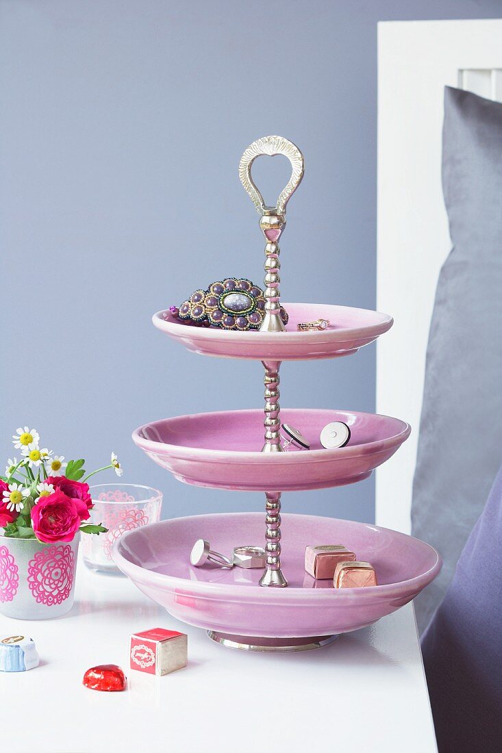 Jewellery and chocolates on pink cake stand