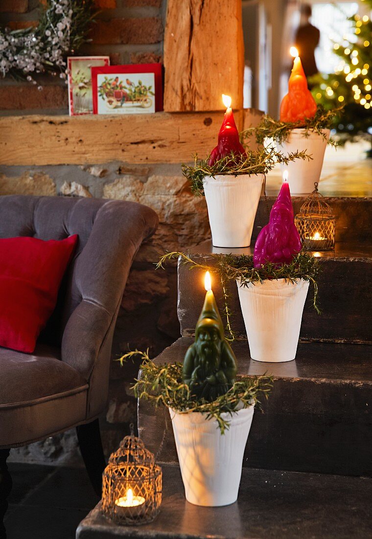 Father Christmas candles in flower pots on a flight of stairs