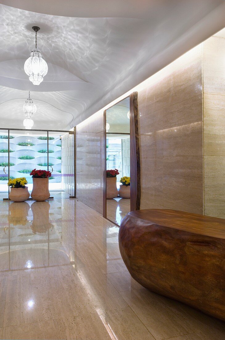 Long marble hallway with double glass doors at end