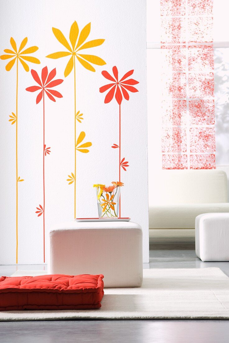 Sunflower wall stickers on partition, white cubic stools and red floor cushion