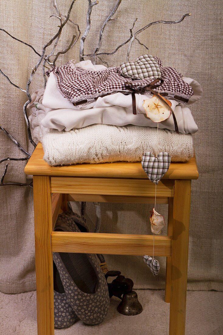 Stack of clothes on wooden stool