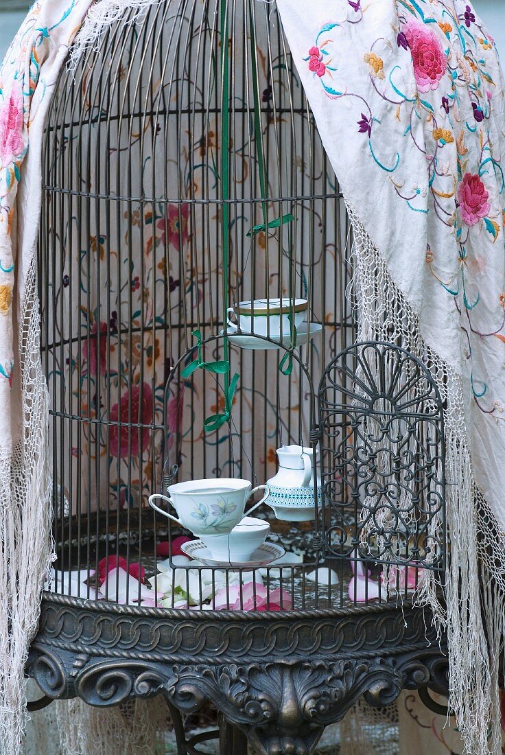 Tealight holders made from old teacups in birdcage
