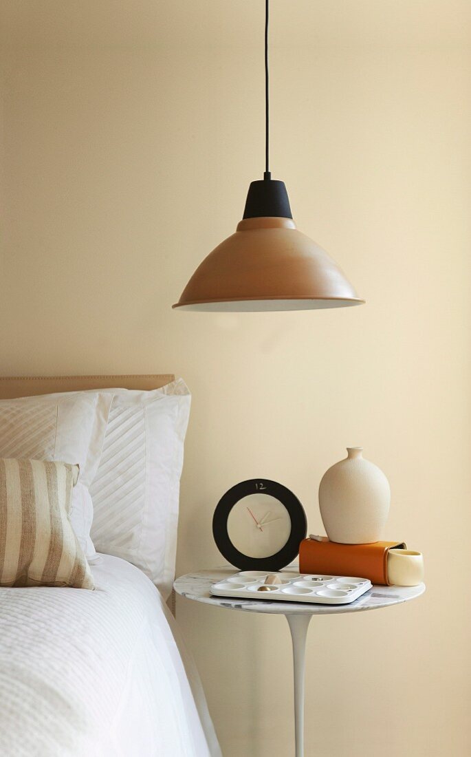 Retro pendant lamp with metal lampshade above bedside table