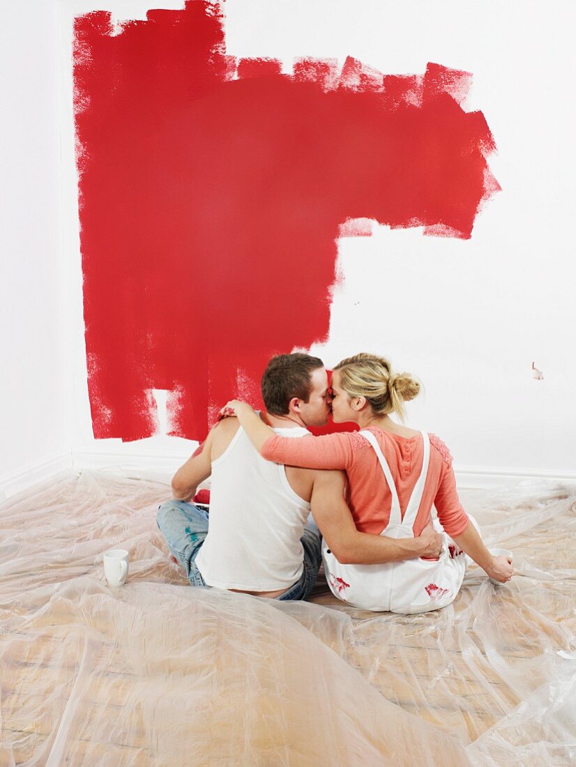 Couple kissing while decorating