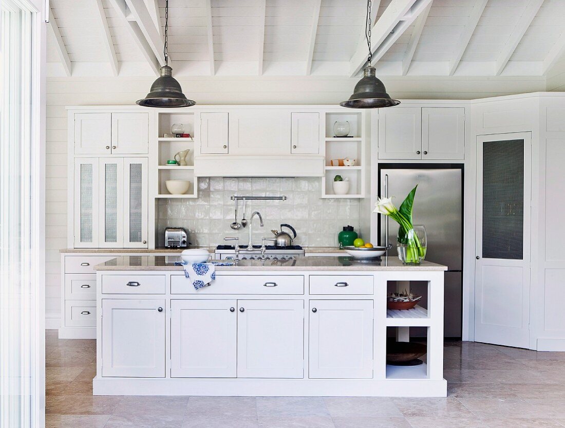 White country house kitchen with stainless steel fronts, a slate and travertine surfaces
