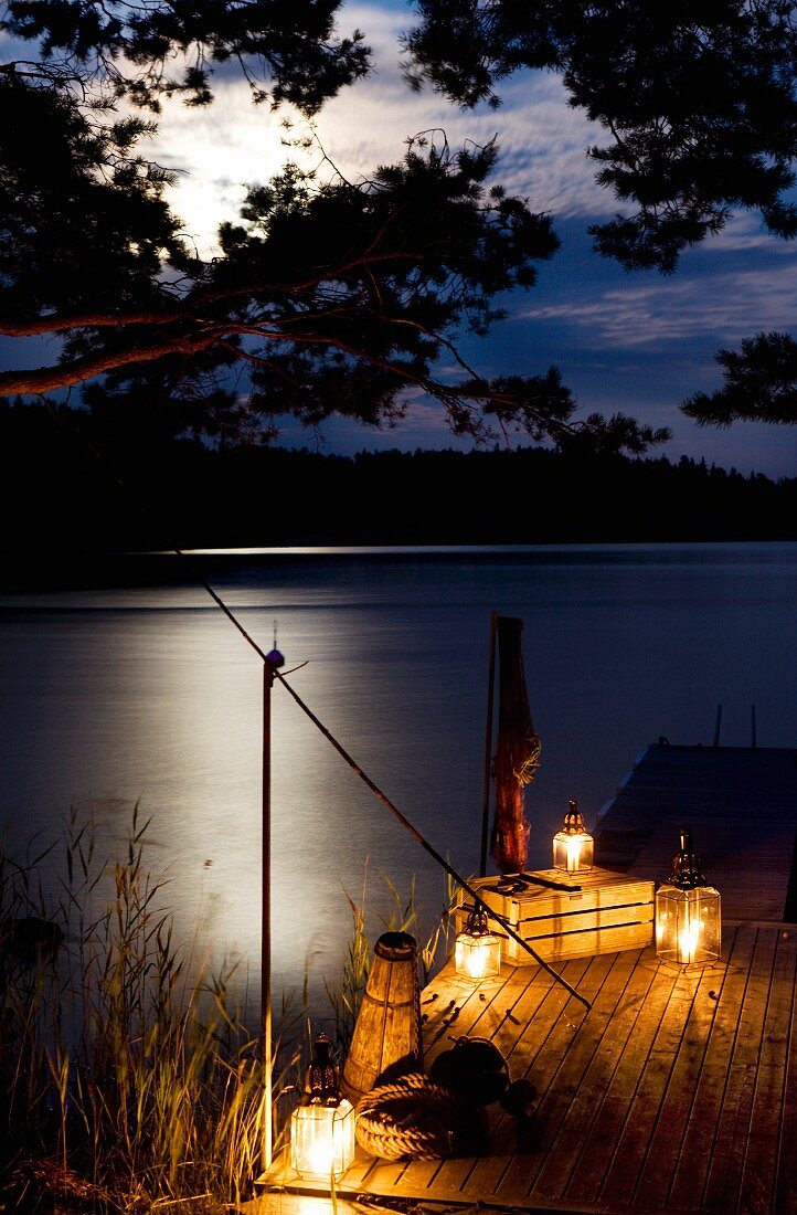 Romantic atmosphere on candlelit jetty under dramatic sky