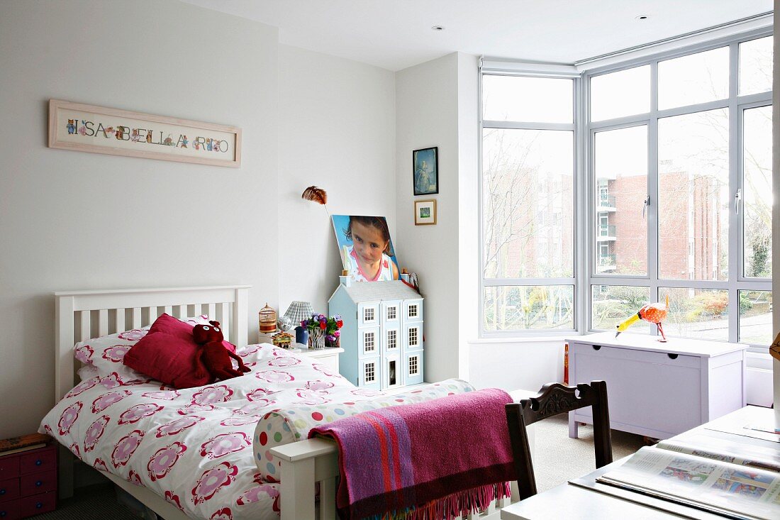 Light and bright teenage bedroom with a glass bay window