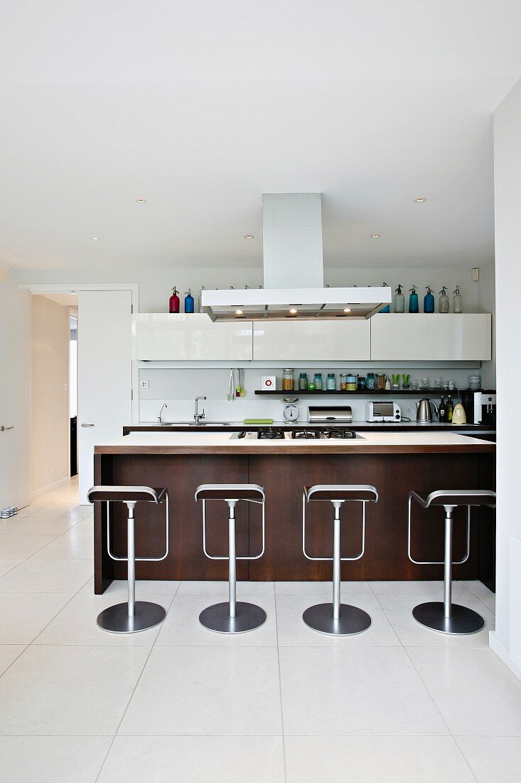 Bar stools in front of kitchen counter in an open kitchen