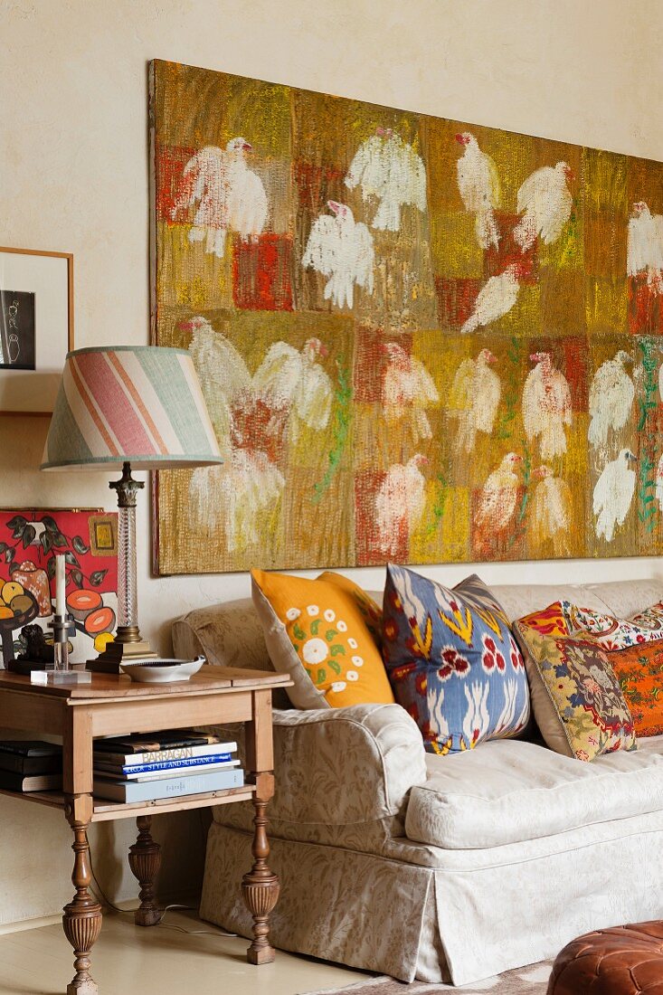 Modernes Gemälde über Vintage-Couch mit bunten Zierkissen