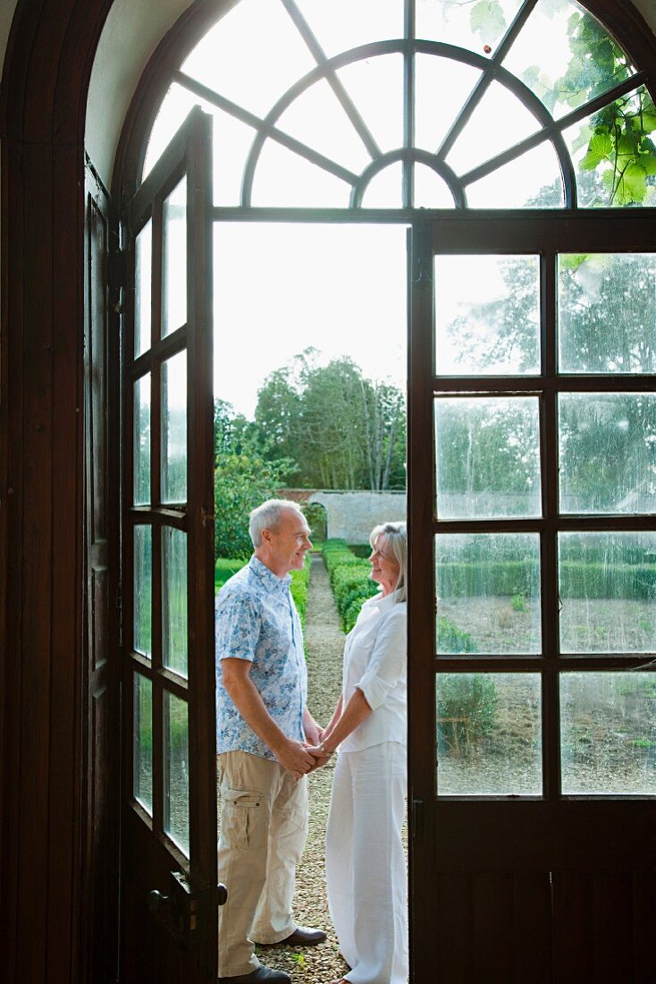 Mature couple by french doors