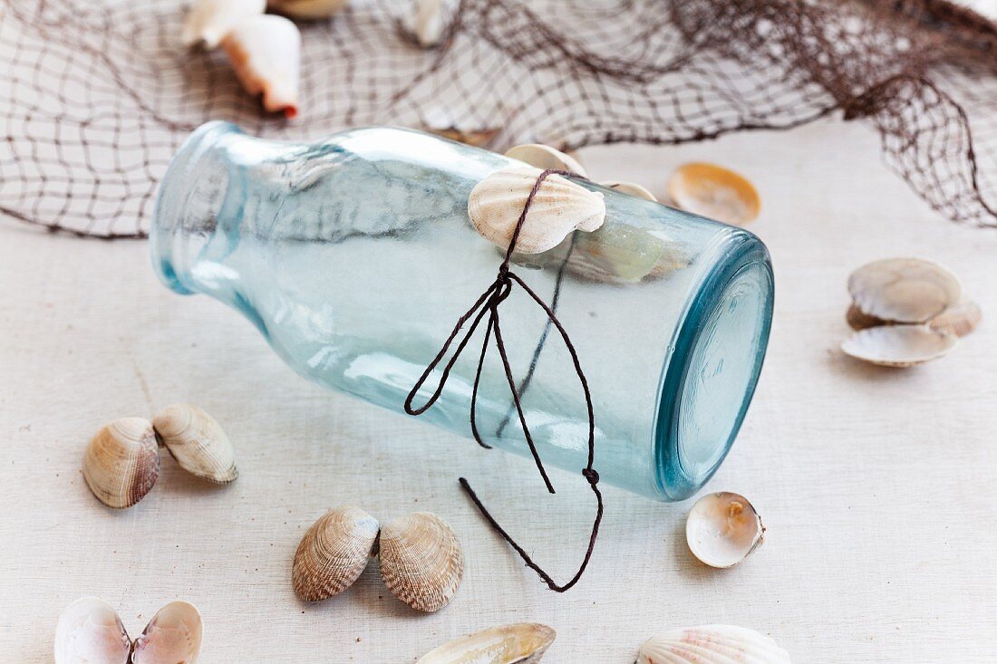 Jar with cord and seashells