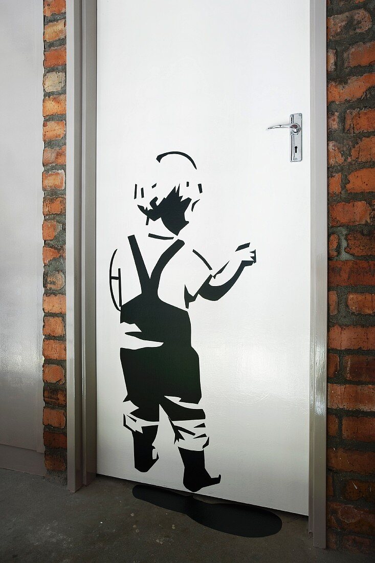 Stencilled picture of child on white door