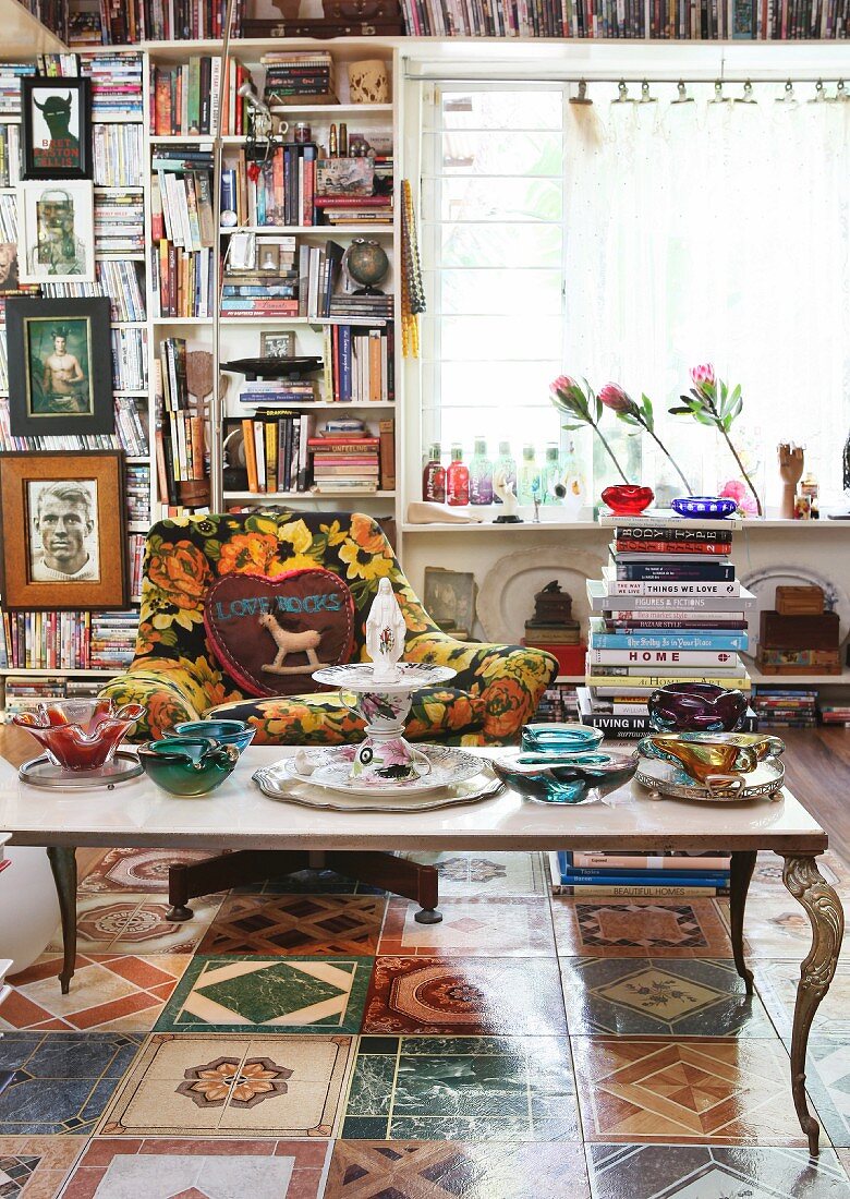 Eccentric collection of books, Murano glass vessels and floor tiles with various motifs